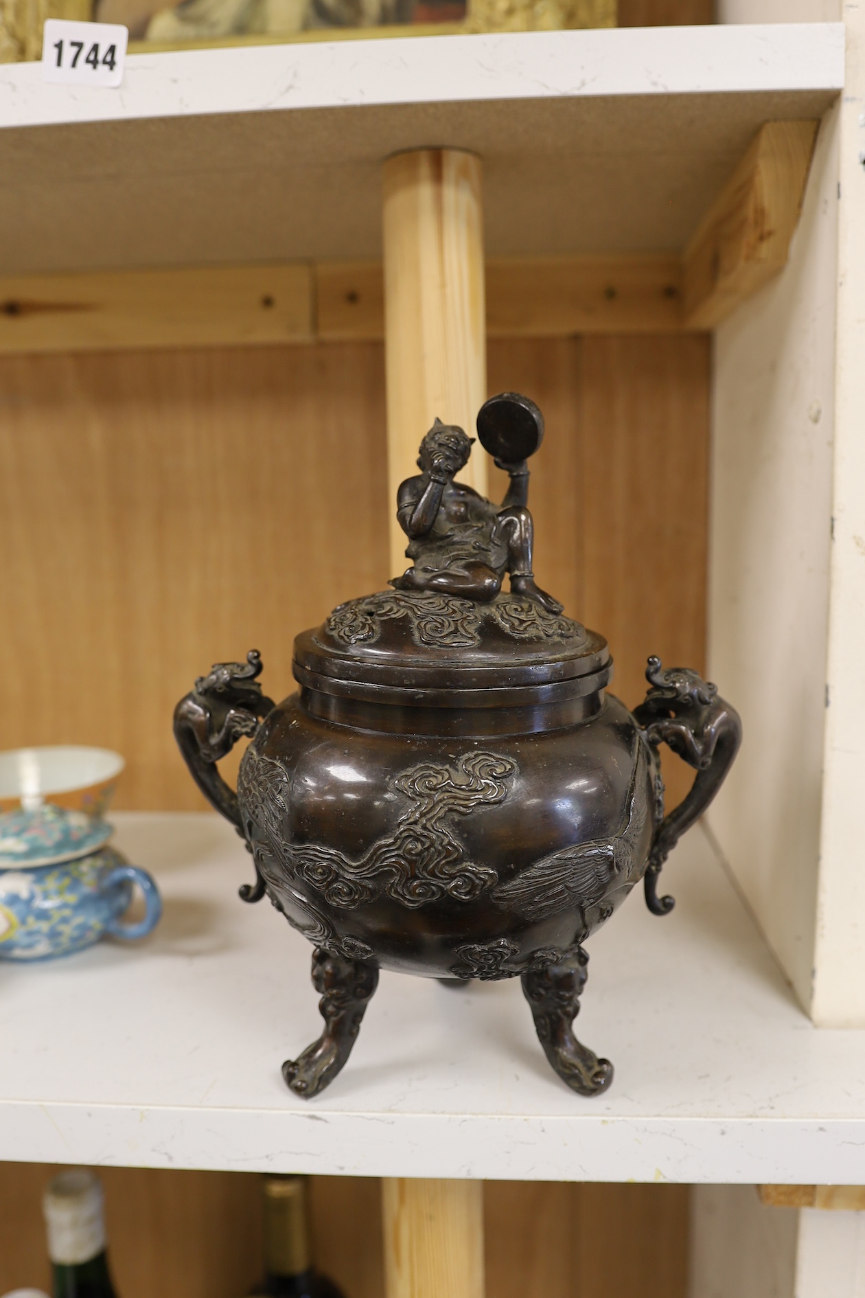 A Japanese bronze dragon handled censer with figural finial to cover, Meiji period, 24cm high. Condition - good